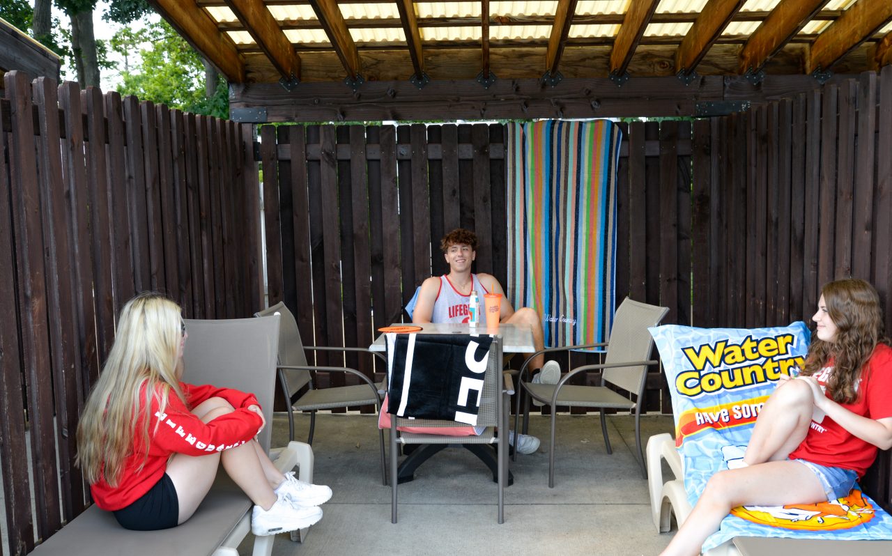 three people in a cabana